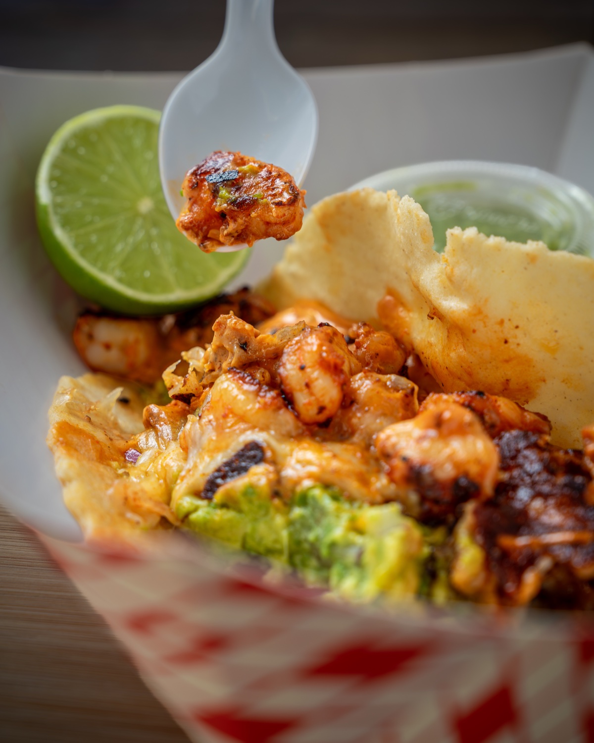 Mariscos El Jaguar grilled shrimp close-up with spoon and lime — food photography