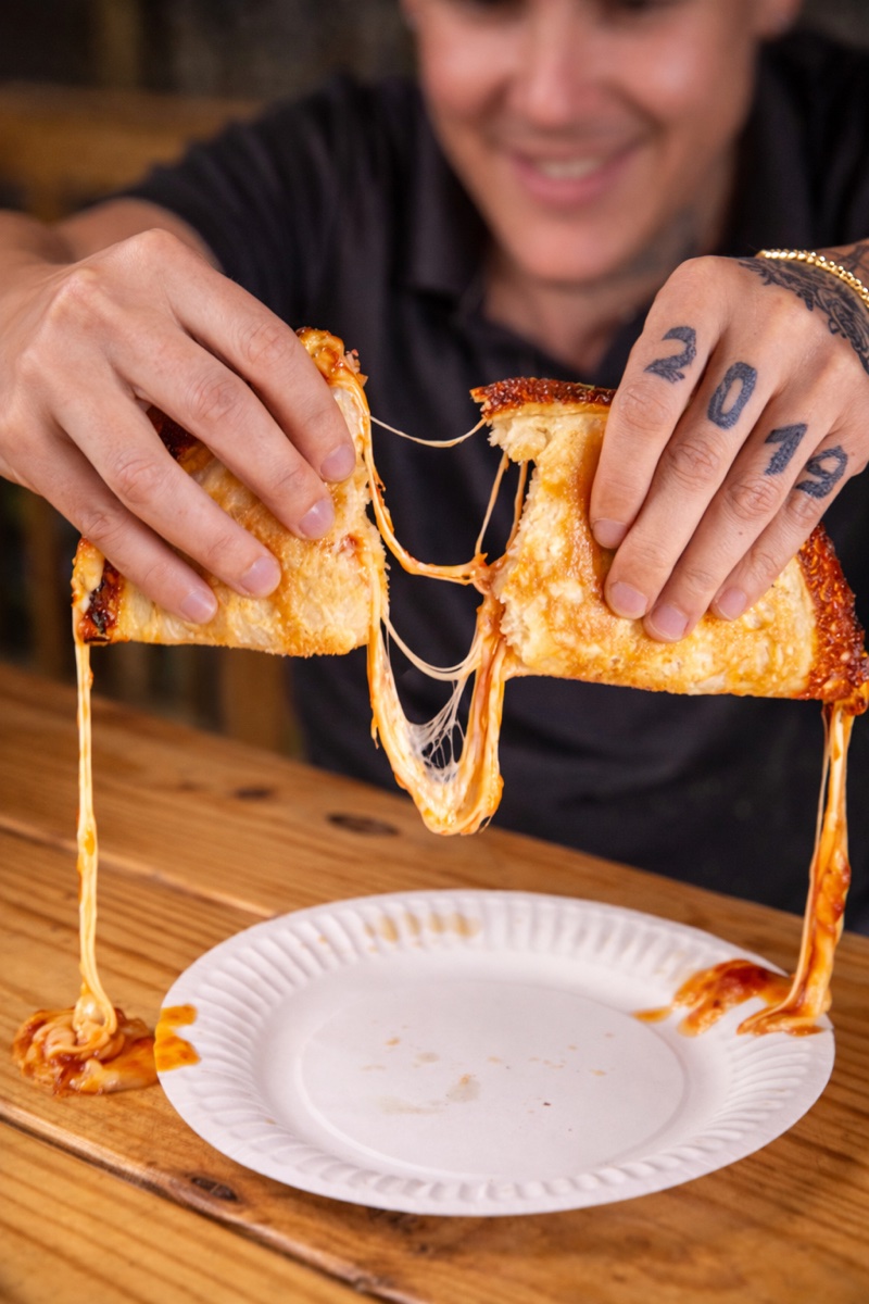 512 Pizzeria cheese-pull slice money shot — Pflugerville pizzeria food photography