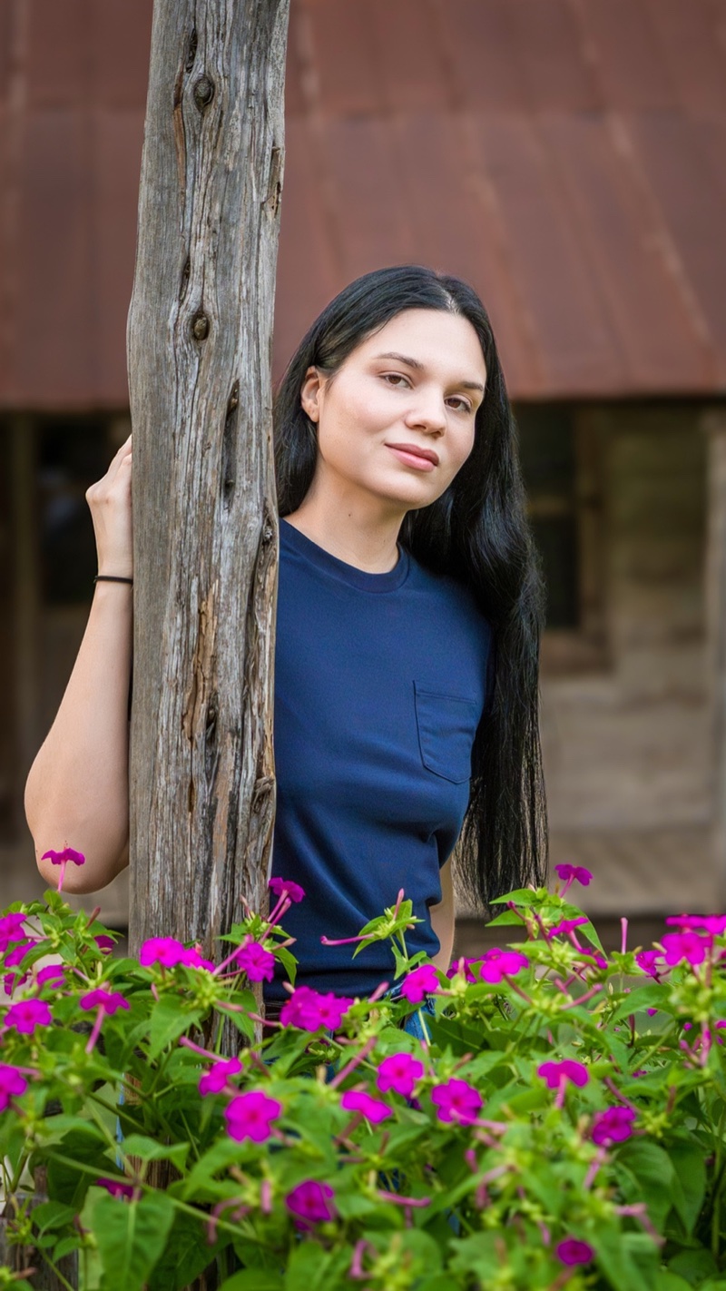 Lifestyle portrait with rustic wood post and flowers — Austin portrait photographer