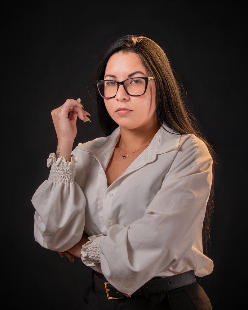Business headshot in cream silk blouse on black backdrop