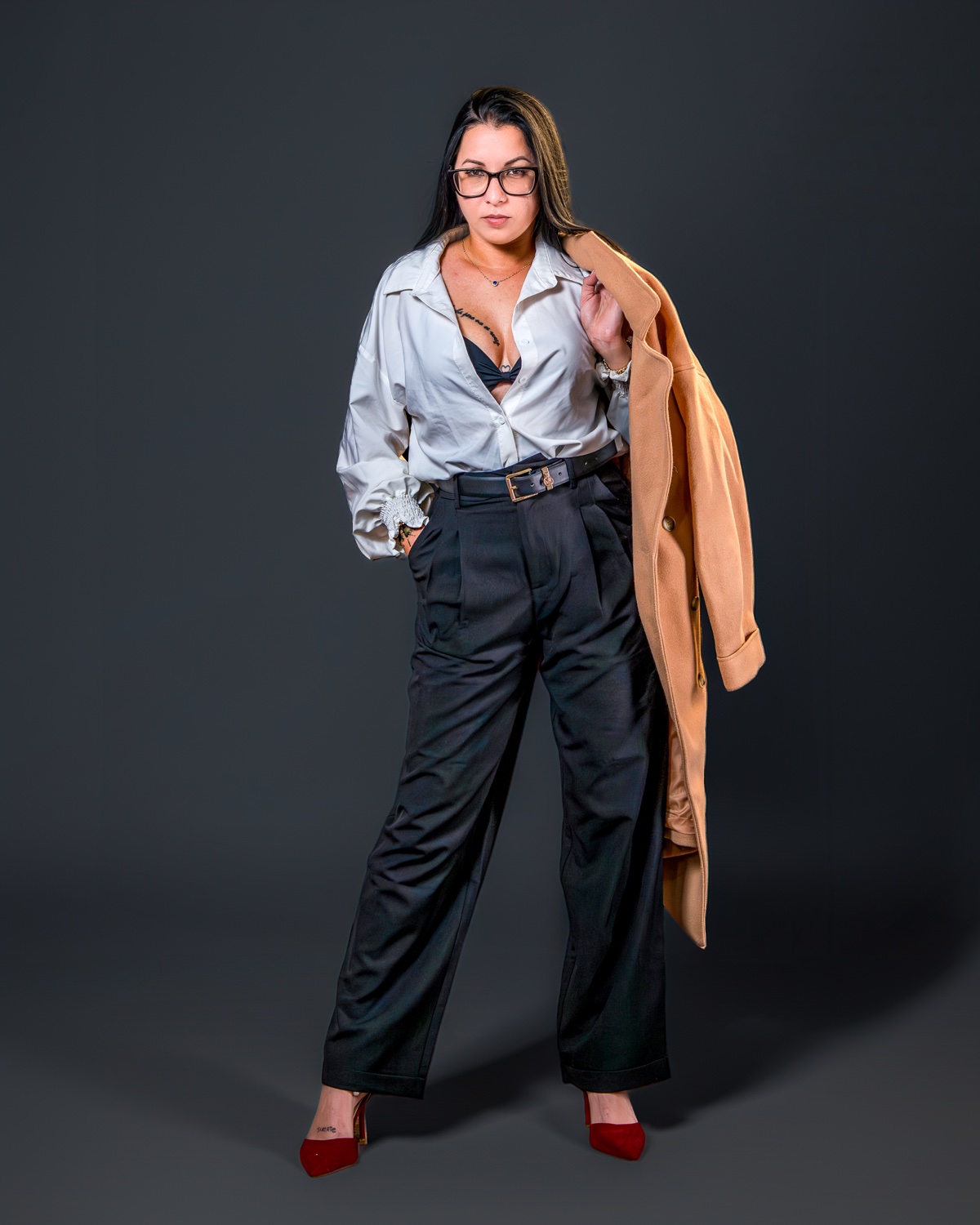 Full-length editorial portrait, camel coat over white shirt and red heels — Austin editorial photographer