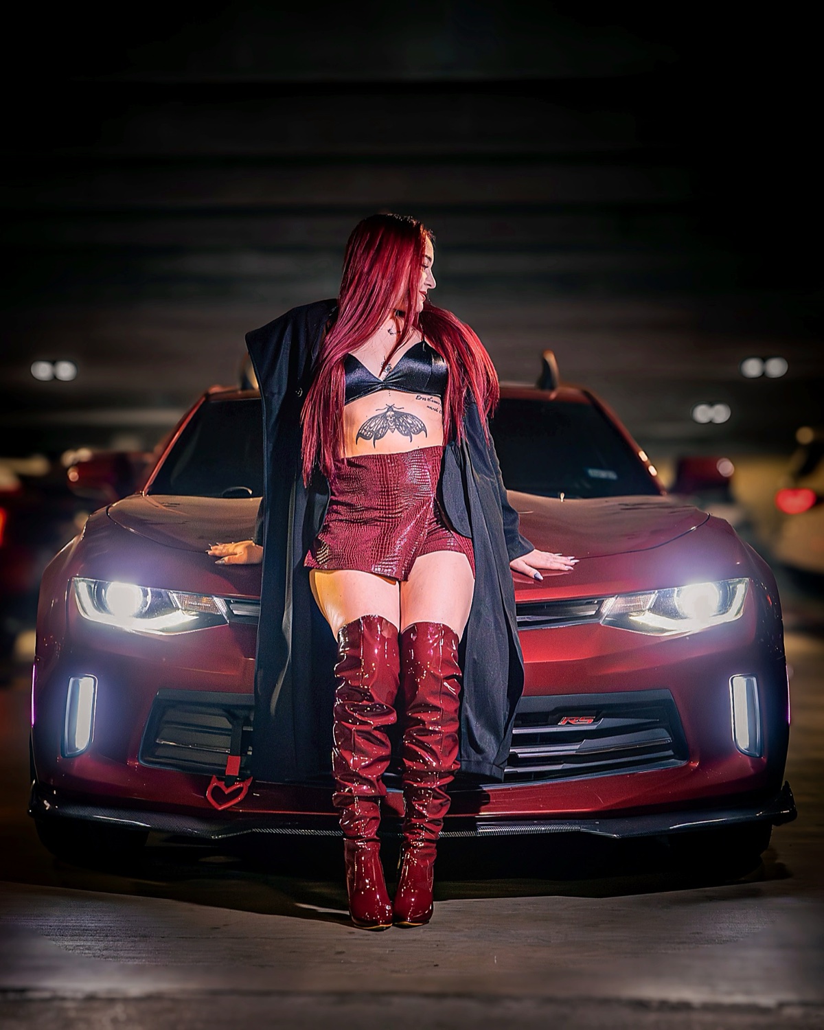 Editorial fashion portrait with red Camaro at night, underground parking — Austin editorial photographer