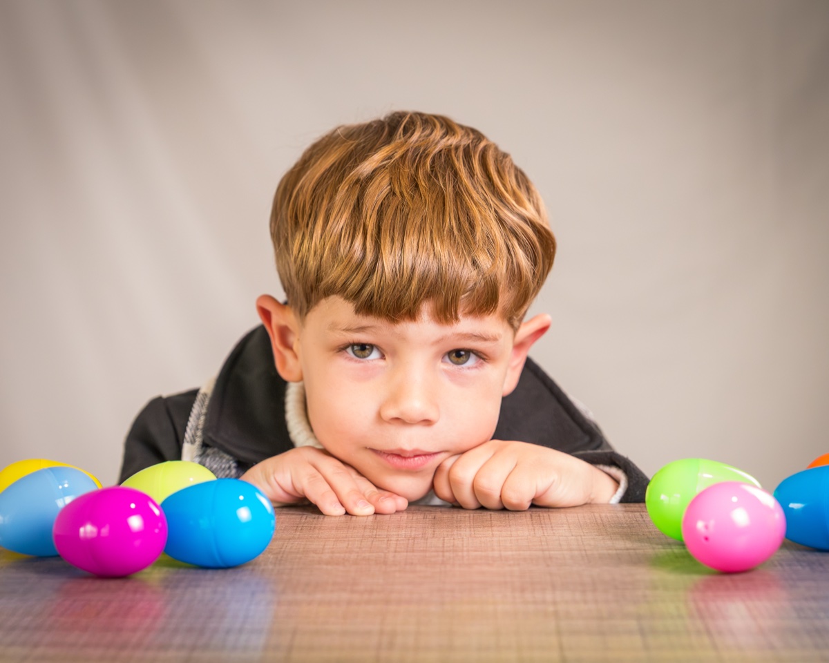 Easter portrait of young boy with colorful eggs on table — Austin children photographer