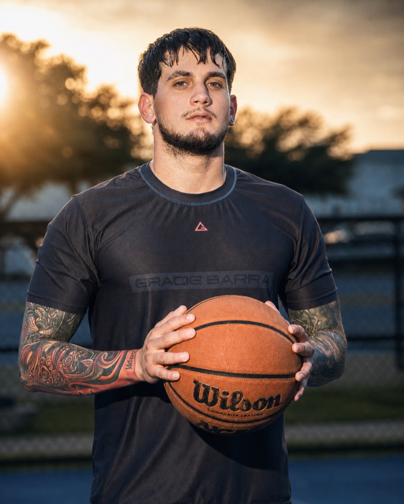 Athlete branding portrait holding Wilson basketball, golden hour — Austin branding photographer